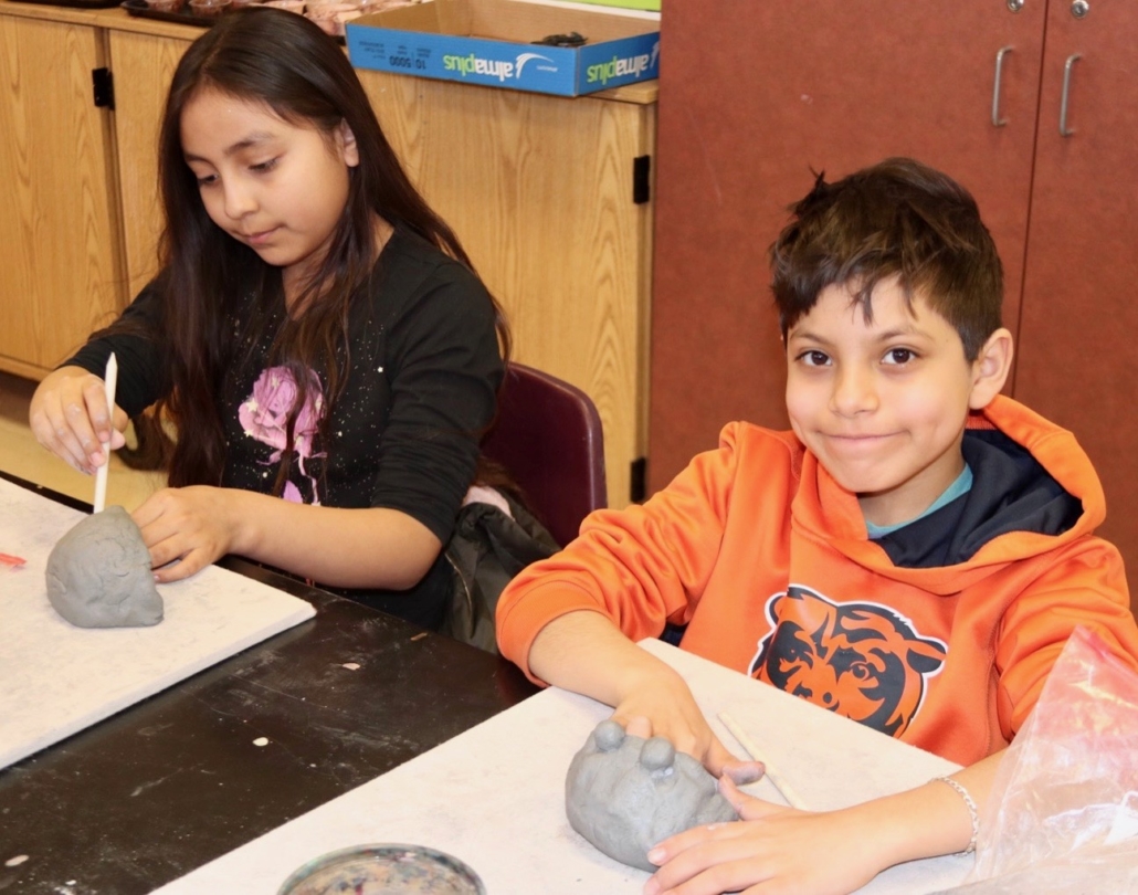 Students molding clay